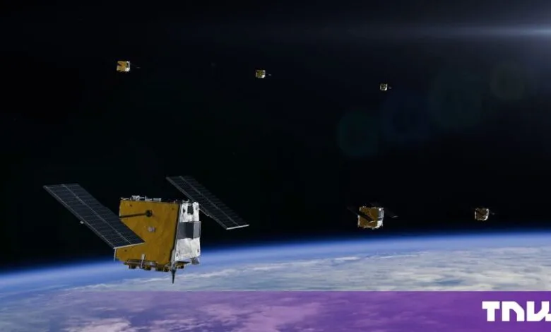 Multiple satellites orbit Earth in space, showcasing solar panels and atmospheric curvature.