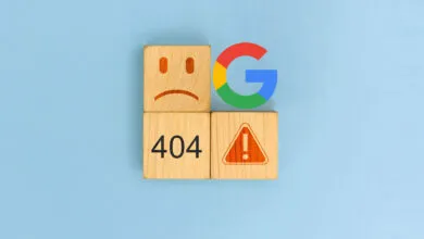 Wooden blocks with a sad face, 404 error, warning sign, and Google logo on a blue background.