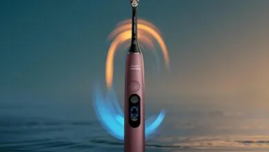 Philips Sonicare toothbrush in rose gold with glowing blue and orange sonic wave effects