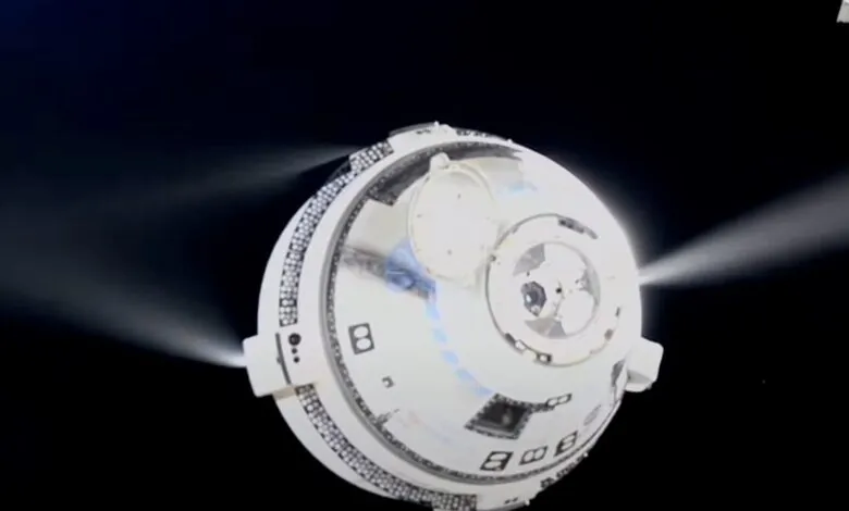 Boeing Starliner spacecraft in orbit with thrusters firing against a black space background.