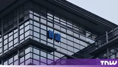 Exterior view of the Zhipu AI office building featuring blue Chinese characters on the glass facade