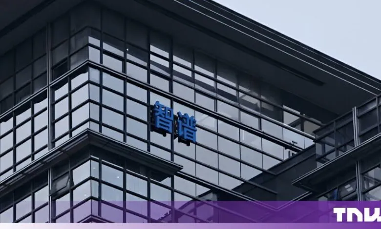 Exterior view of the Zhipu AI office building featuring blue Chinese characters on the glass facade