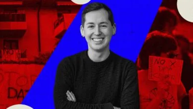 Portrait of a smiling person with crossed arms against a graphic background of red and blue.