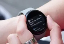 Close-up of a person wearing a Google Pixel Watch 3 displaying a smart home notification.