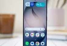 Close-up of a modern smartphone displaying a customized home screen with widgets and colorful app icons.