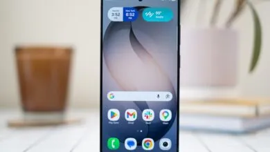 Close-up of a modern smartphone displaying a customized home screen with widgets and colorful app icons.