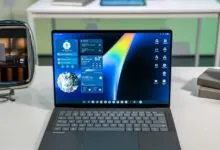 Asus Googlebook laptop displaying a blue desktop interface with widgets on a white desk.