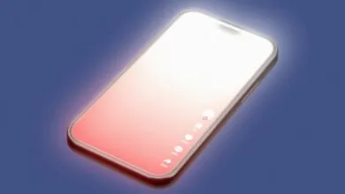 Glowing smartphone angled on a dark blue surface displaying a pink and white gradient screen.
