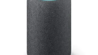 Charcoal gray Amazon Echo smart speaker with a glowing blue light ring around the top.