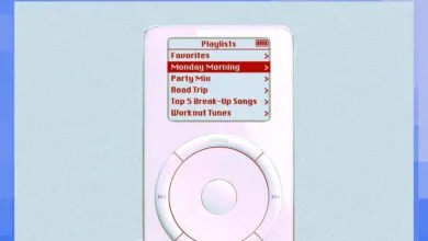 Close-up of a classic white iPod showing the playlists menu on its screen.