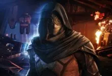 A hooded figure in armor with a mechanical mask stands in a dimly lit, fiery industrial room.