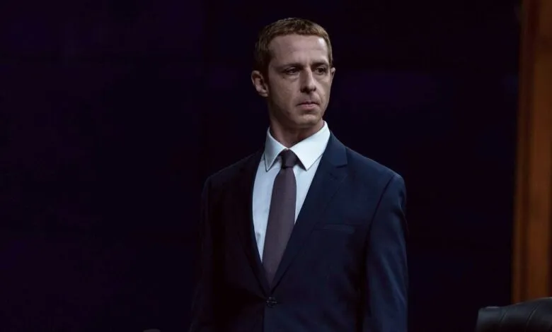 Jeremy Strong as Kendall Roy in a sharp suit against a dark background.