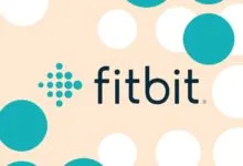 Fitbit logo with teal dotted icon and dark text against a beige background with teal and white circles.
