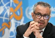 WHO Director-General Tedros Adhanom Ghebreyesus speaking in front of the UN flag