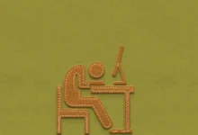 Felt art of a person sitting at a desk with a computer, looking exhausted.