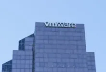 Top facade of the VMware office building in Bellevue, Washington against a clear blue sky.