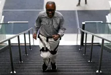 Boston Globe reporter Hiawatha Bray happily climbs stairs while wearing the Hypershell X Ultra exoskeleton.
