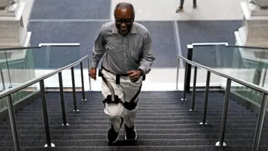Boston Globe reporter Hiawatha Bray happily climbs stairs while wearing the Hypershell X Ultra exoskeleton.