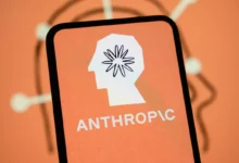 A smartphone displaying the Anthropic AI logo featuring a head outline and starburst pattern.
