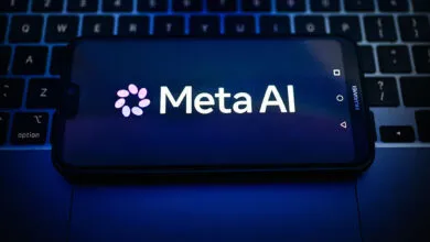 Meta AI logo displayed on a smartphone screen resting over a laptop keyboard