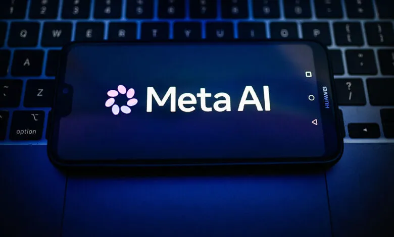 Meta AI logo displayed on a smartphone screen resting over a laptop keyboard