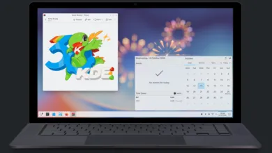 Laptop displaying a KDE desktop with a 30th-anniversary Konqi the dragon graphic.