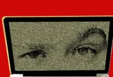 A laptop screen displays a pixelated face composed of dark specks against a textured, static-like beige backdrop.