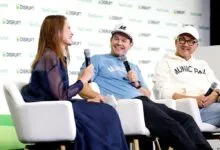 Mark Wahlberg and co-founders speaking on stage at a TechCrunch Disrupt panel discussion.