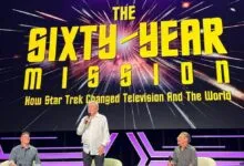 William Shatner speaks on stage beneath a large screen for The Sixty Year Mission at NYCC.
