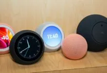 Five spherical Amazon Echo smart speakers displayed on a wooden surface.