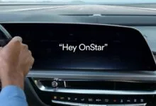 Driver's view of a modern car interior with the OnStar AI assistant text on the dashboard screen.