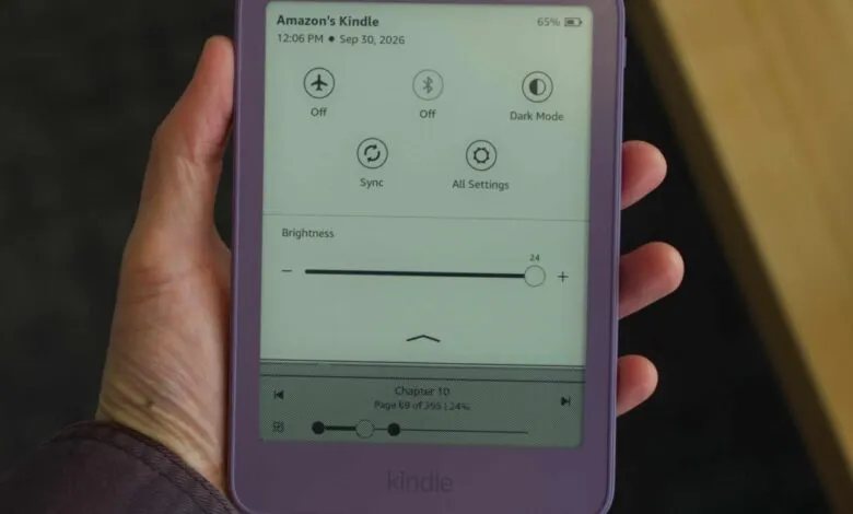 A person holding a purple Amazon Kindle e-reader displaying quick settings and brightness controls.