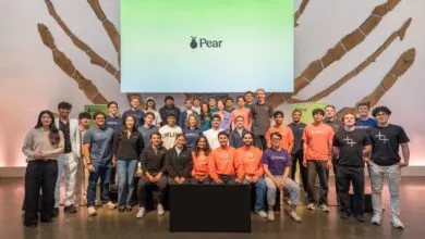 Group of diverse startup founders posing together on stage at a Pear Demo Day event.
