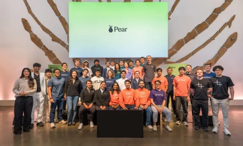 Group of diverse startup founders posing together on stage at a Pear Demo Day event.