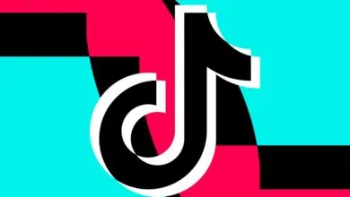 The iconic black TikTok logo features a white outline, set against a vibrant background of pink, cyan, and black shapes.