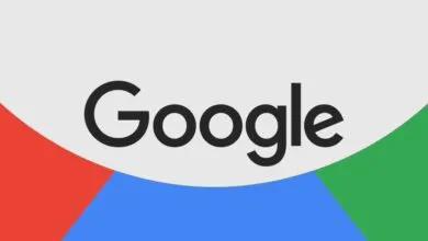 The dark grey Google logo centered over a background of red, blue, and green curves.