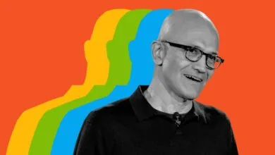 Black and white portrait of Microsoft CEO Satya Nadella against a vibrant red background with colorful silhouettes