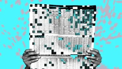 Hands holding a financial newspaper with digital glitch and pixelated corruption effects.