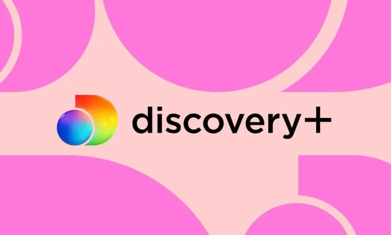 Discovery Plus logo featuring a colorful gradient globe and black text against a pink background