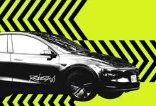Monochrome Tesla Robotaxi graphic against a bright yellow and black chevron background.