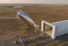 Sceye-ST1 stratospheric airship launches outside a large hangar at sunrise.