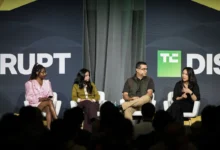 Four diverse panelists sitting on stage in white chairs discussing at TechCrunch Disrupt.