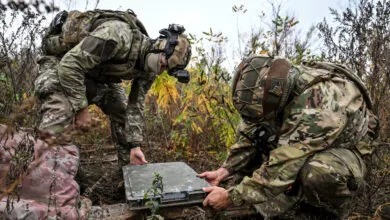 Ukrainian National Police officers setting up a Starlink terminal in Donetsk region