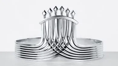 Sleek, polished silver crown featuring architectural lines and diamond-shaped spikes