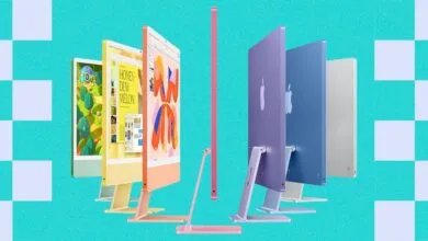 Colorful lineup of Apple iMac desktop computers in green, yellow, orange, pink, purple, blue, and silver.