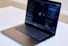 Laptop displaying a space simulation program with code and celestial graphics.