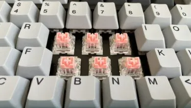 Close-up of mechanical keyboard with keycaps removed to reveal pink Varmilo EC switches.