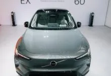 Front view of a grey Volvo EX electric vehicle on display in a modern showroom