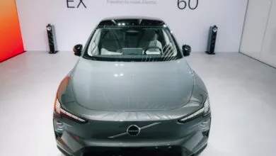 Front view of a grey Volvo EX electric vehicle on display in a modern showroom