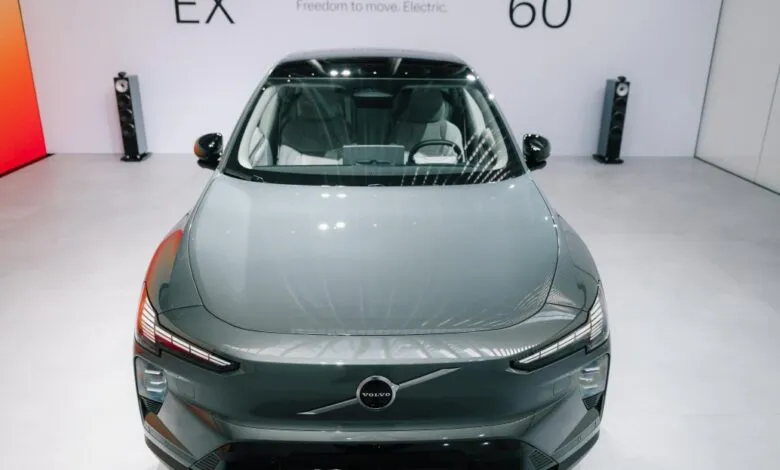 Front view of a grey Volvo EX electric vehicle on display in a modern showroom